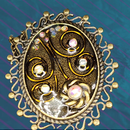 Antique-Inspired Gemstone Pendant with ornate design and gold-toned frame