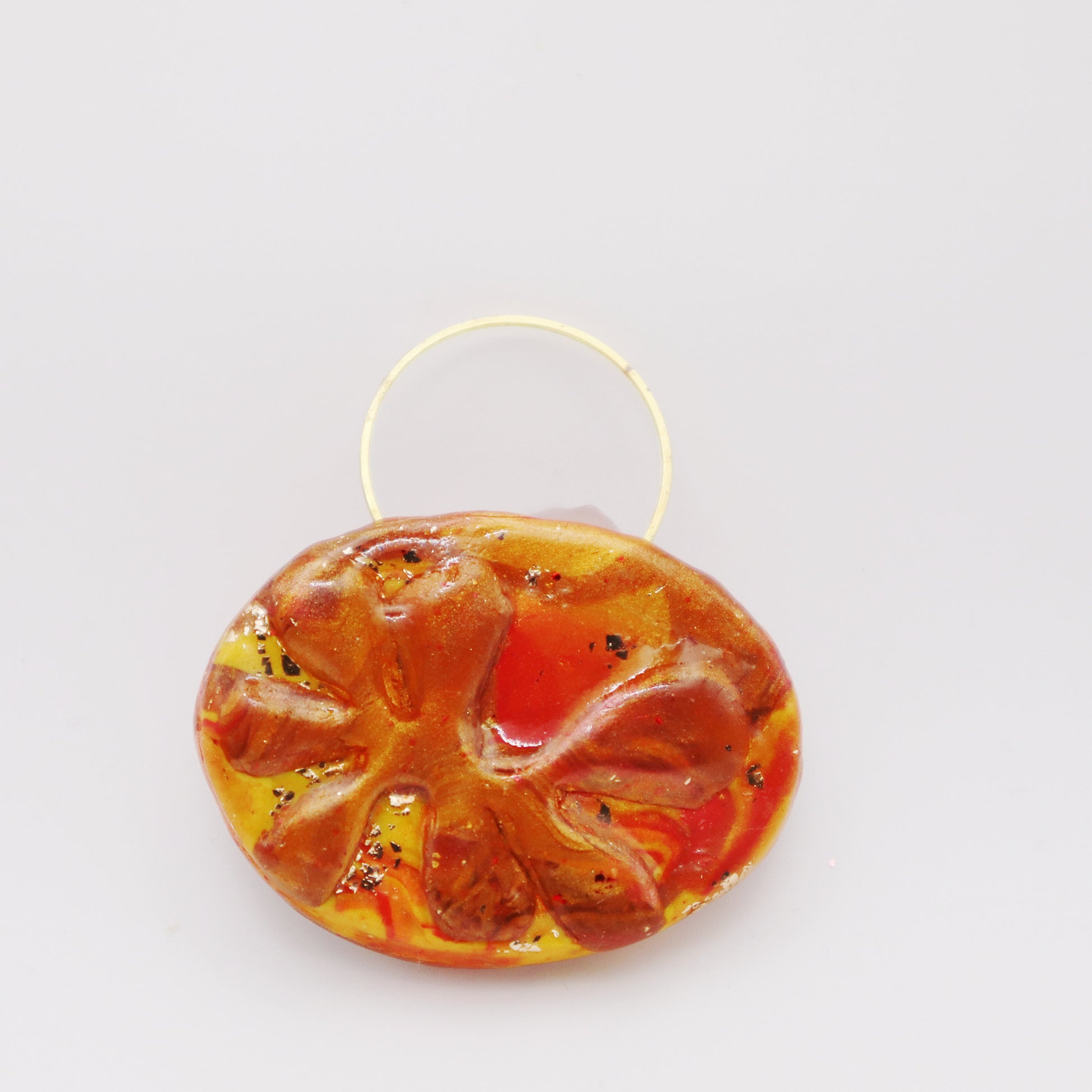 Amber Flame Polymer Clay Pendant with warm amber hues and handcrafted design