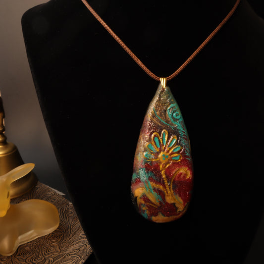 Bohemian teardrop pendant with vibrant turquoise, crimson, and gold floral motif