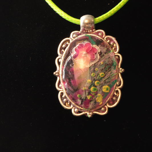 Vintage Floral Resin Pendant with intricate metal frame and green cord