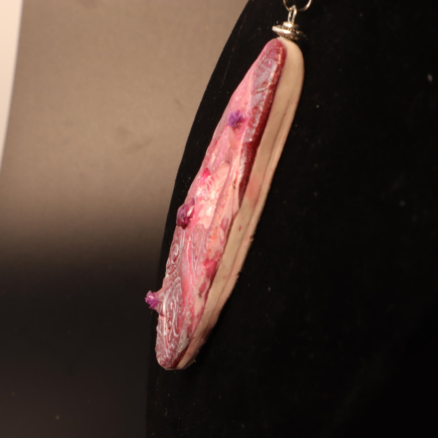 Handcrafted polymer clay pendant in rose and purple tones, embossed with intricate floral designs and silver-tone bail