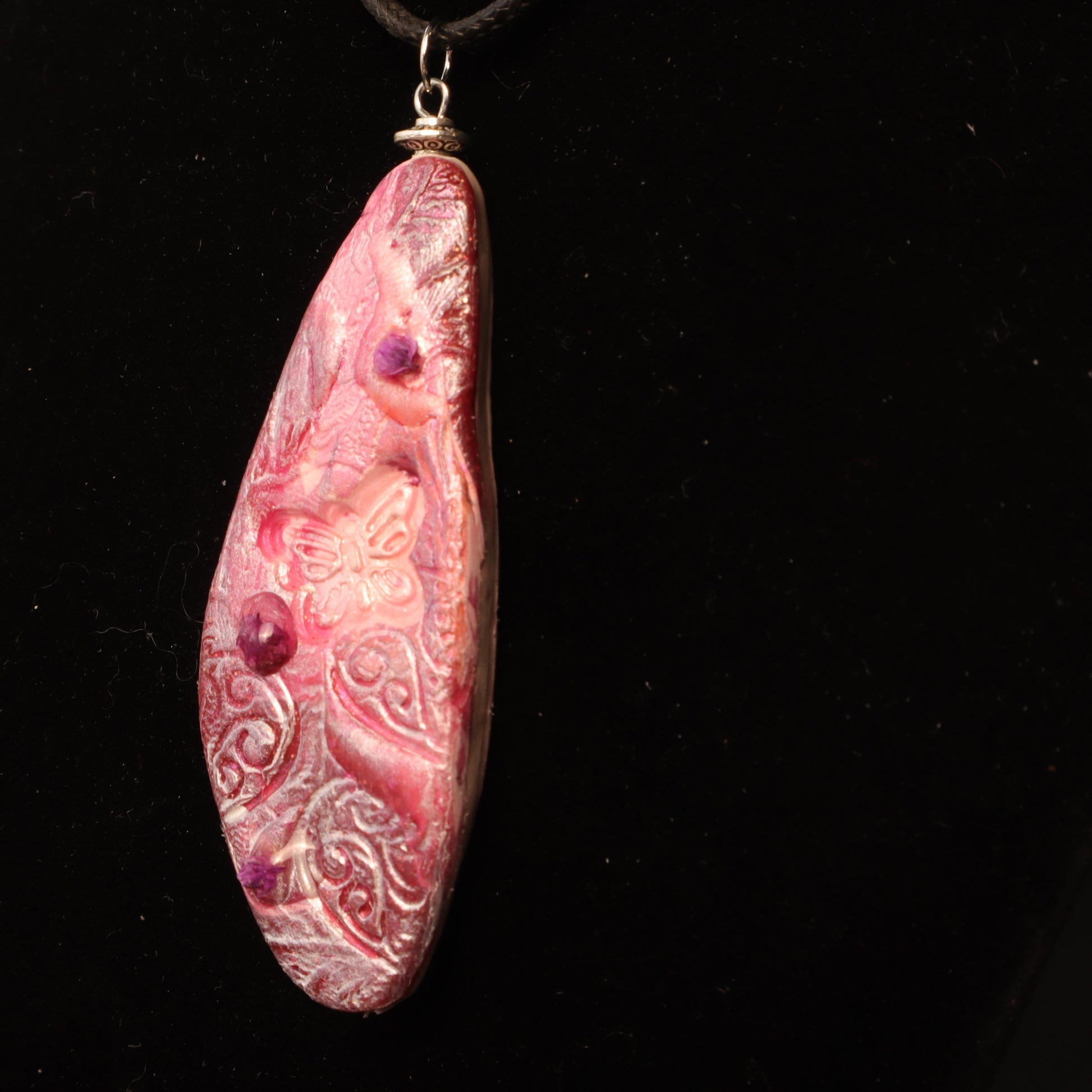 Handcrafted polymer clay pendant in rose and purple tones, embossed with intricate floral designs and silver-tone bail