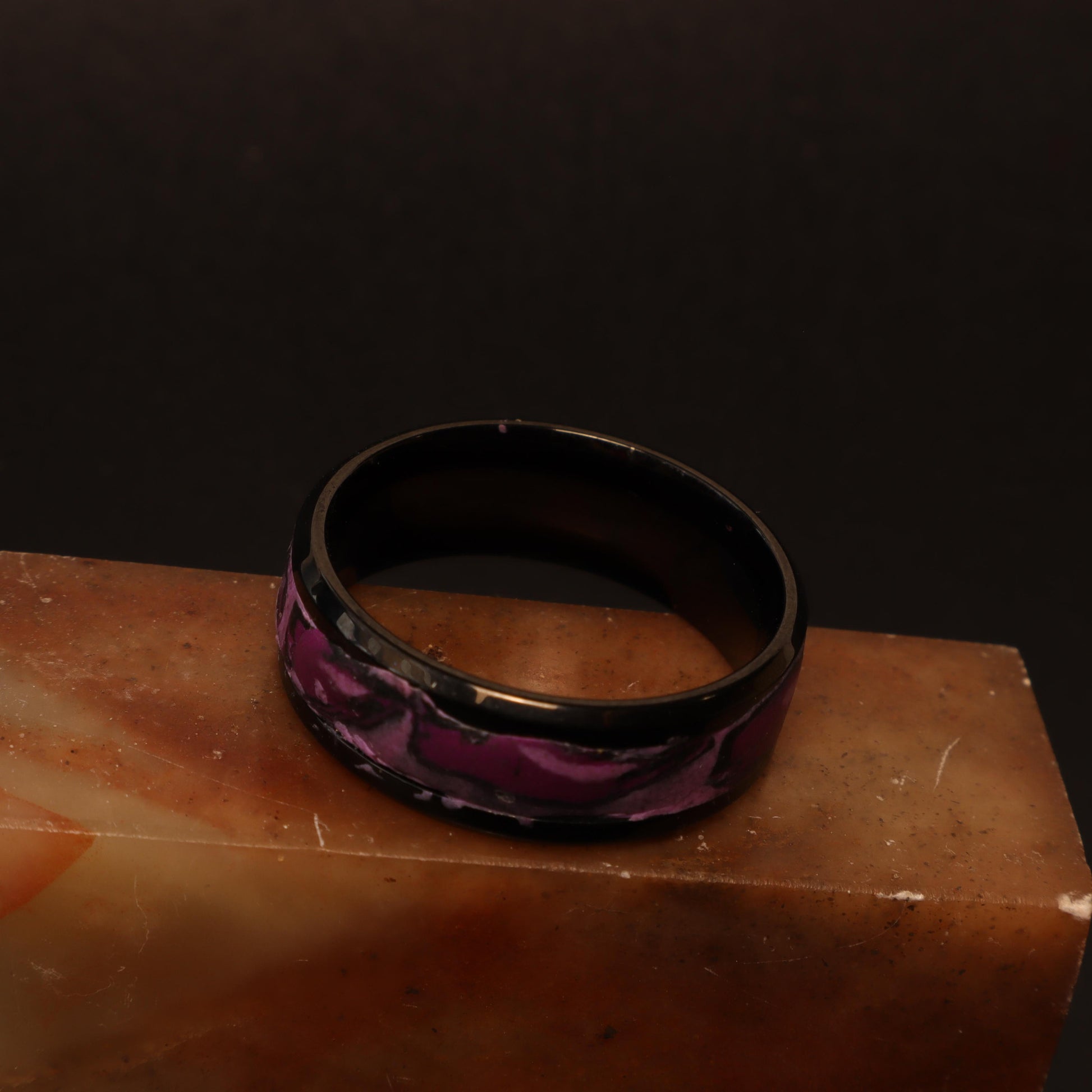 Black resin ring with a marbled orchid purple design