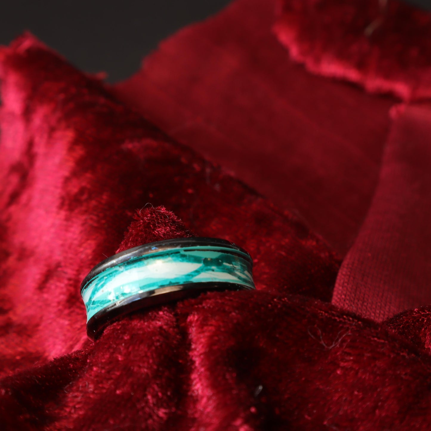 Black resin ring with a turquoise marbled inlay featuring blue and white accents