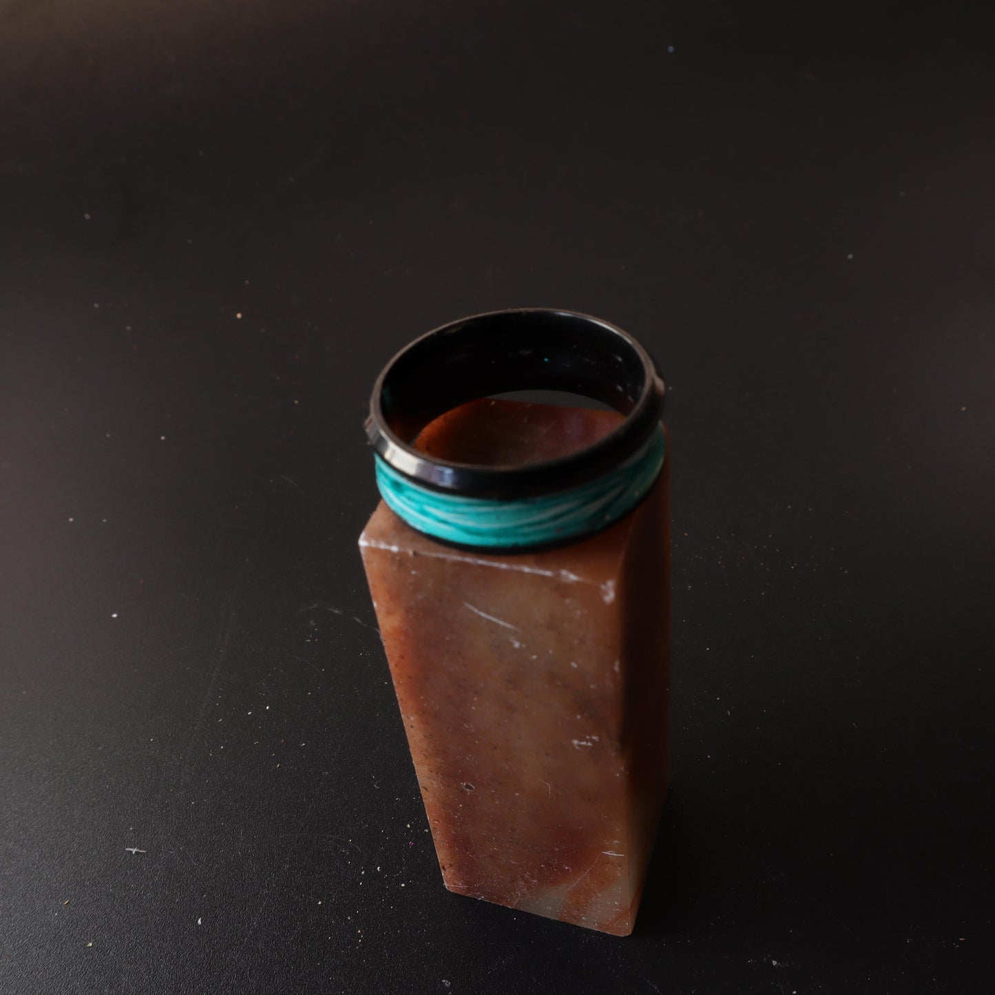 Black resin ring with a turquoise marbled inlay featuring blue and white accents