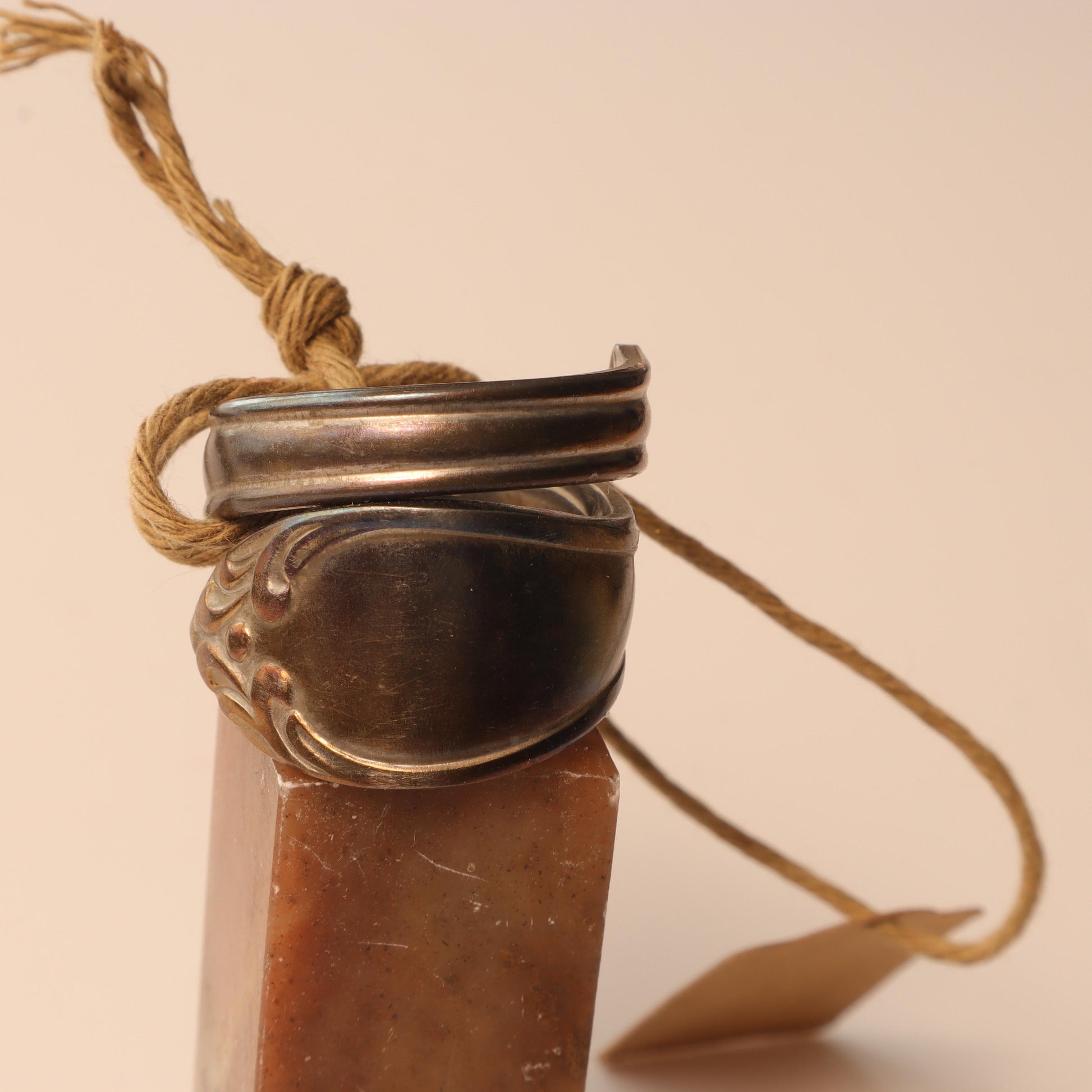 Unique stainless steel spoon ring with heat treatment on wood display